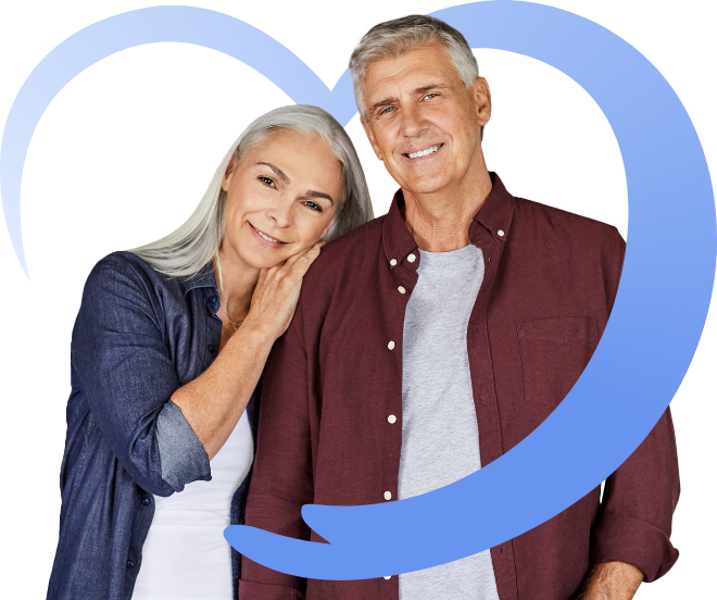 A smiling mature couple pose together with the woman resting her head on the man’s shoulder, framed by a large blue heart graphic on a transparent background.