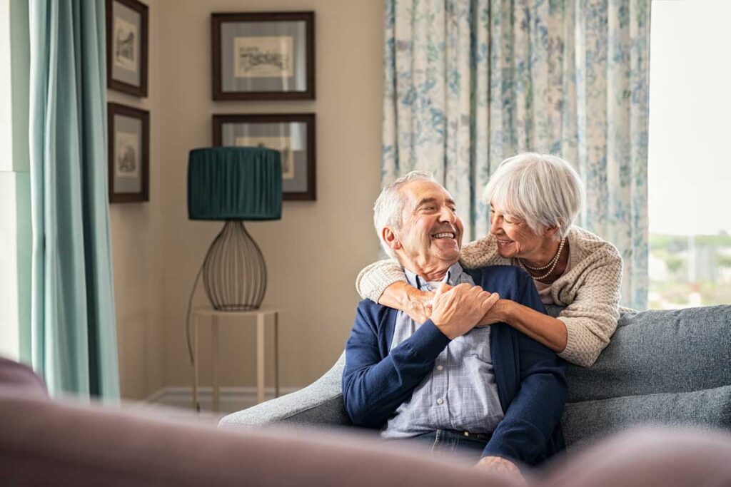 senior couple hugging on couch